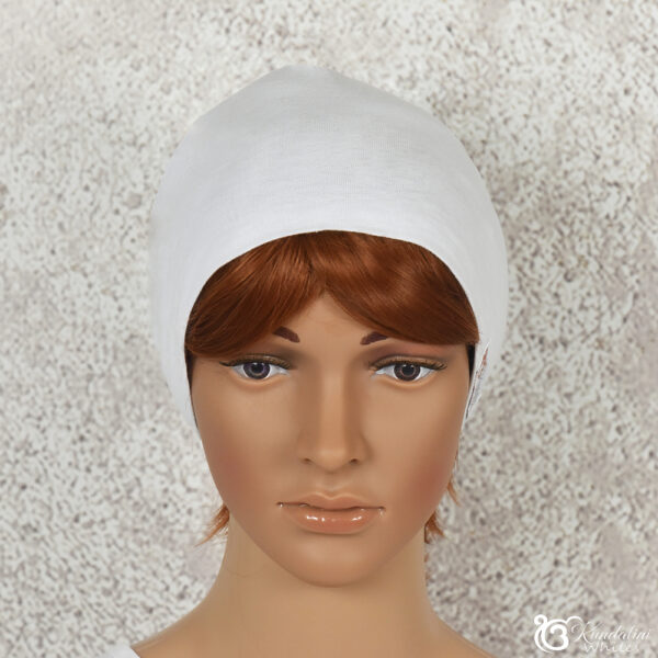 Frontal view of female model wearing a white cotton beanie